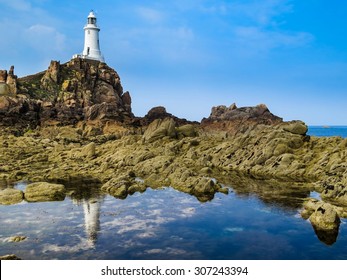 Lighthouse on the rock and reflection. Jersey, Channel Islands