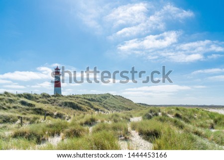 Lighthouse red white on dune. Sylt island – North Germany. Focus on background with lighthouse.