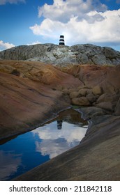 Lighthouse reflected in pond