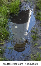 Lighthouse Reflection In Mud Puddle