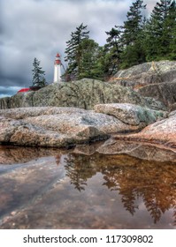 Lighthouse reflection in small tidal pool in lighthouse park West Vancouver
