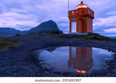 Lighthouse Reflection in a Water Puddle