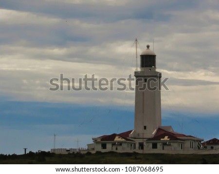 lighthouse of Santa Marta, with its white tower contrasting with the blue sky of white clouds, Laguna, SC, Brazil