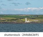 A lighthouse seen from the water at North Channel, Scotland, United KIngdom