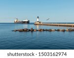 A Lighthouse And A Ship On Lake Superior