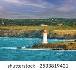 Lighthouse and a ship wreck at the entrance of Sydney harbor, Nova Scotia, Canada