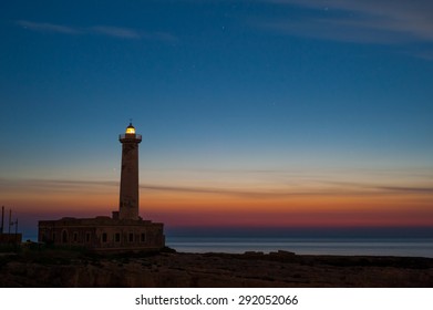 Lighthouse and starry night before the sunrise - Powered by Shutterstock