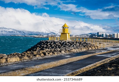 Lighthouse and stone embankment of Reykjavik against the backdrop of mountain peaks covered with snow. Iceland. - Powered by Shutterstock