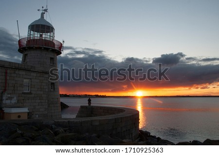 Lighthouse with sunset background in Howth.