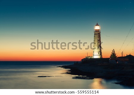 lighthouse at sunset in the twilight in clear weather at Cape Tarkhankut in Crimea