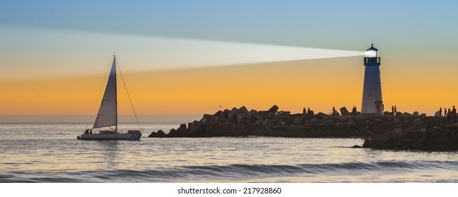 Lighthouse And Surf Boat With Light Beam At Sunset