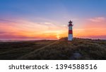 Lighthouse Sylt List east - Ellenbogen at sunset with beautiful red and yellow clouds - high dynamic range