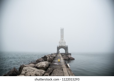 Lighthouse Through Fog Along Pier