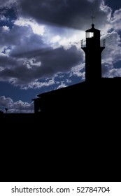 Lighthouse under dark cloudy sky