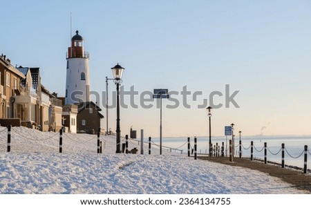 Lighthouse of Urk Netherlands during winter with snow in the Netherlands. Urk village during winter