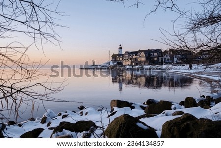 Lighthouse of Urk Netherlands during winter with snow in the Netherlands. view from the beach at the village Urk