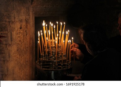 Lighting Candles Inside A Greek Orthodox Church.