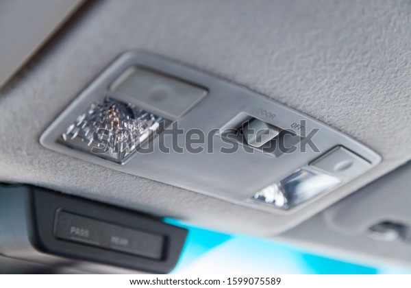 Lighting\
control inside the car from the top on the instrument panel behind\
the rear-view mirror in white with\
buttons