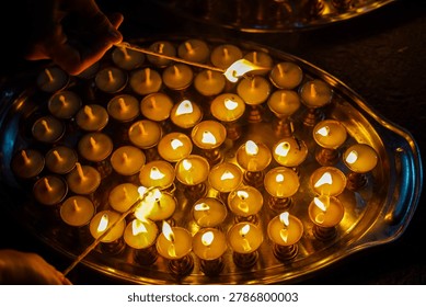 lighting earthen lamp during the Bunga Dyah Jatra in Patan, Lalitpur, Nepal.