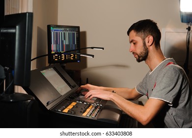 A lighting engineer works with lights technicians control on the concert show. Professional light mixer, mixing console. Equipment for concerts.