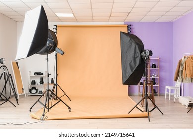 Lighting Equipment And Beige Cyclorama In Modern Photo Studio