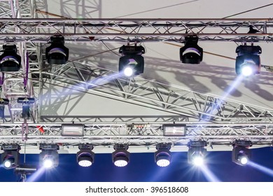 lighting equipment high above an outdoor concert stage