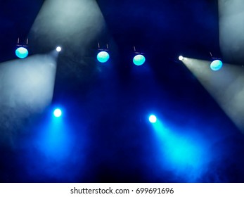 Lighting equipment on the stage. The spotlight through the smoke. Theater performance. - Shutterstock ID 699691696