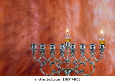 Lighting The First Candle On A Hanukkah Of A Burning Chanukah Candlestick With Candles Menorah A Traditional Jewish Holiday