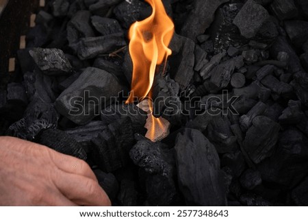 Lighting the grill with a firestarter