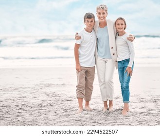 Lighting makes the picture. Shot of a mature woman and her grandchildren bonding at the beach. - Powered by Shutterstock