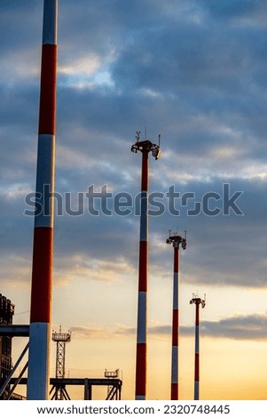 Lighting masts at the airport in cloudy weather.