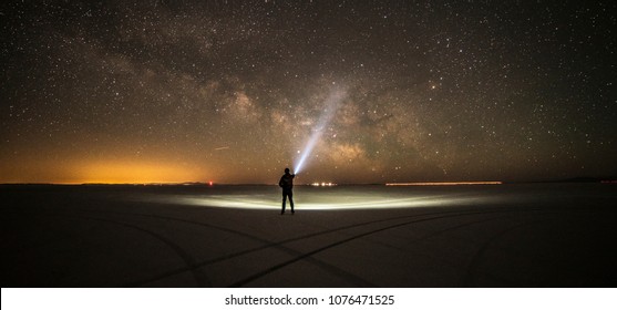 Lighting The Milky Way With A High Lumen Flashlight In The Middle Of Bonneville Salt Flats,Salt Lake City,Utah,USA