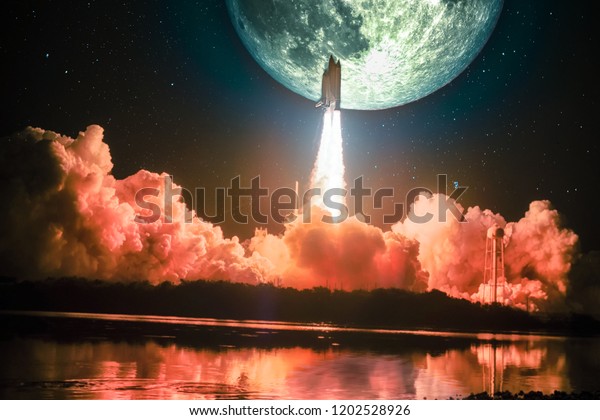 Lighting up the night sky, as well as the water\
nearby, spacship blazes into the moon mission. Huge moon is on the\
night sky surrounding by galaxy. Elements of this image furnished\
by NASA.