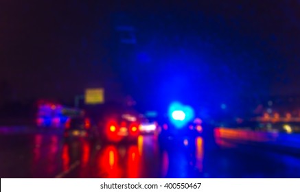  lighting  of police car in the night  during  accident on the road when raining.