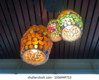 Lighting of stainedglass hang on ceiling in coffee shop.