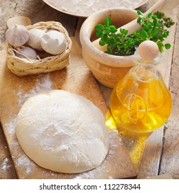 Lightly Floured Dough Left To Rise On A Wooden Board In The Kitchen To Be Used For A Pizza Base