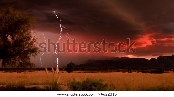 Lightning Against Dramatic Red Sunset Clouds During Desert Summer