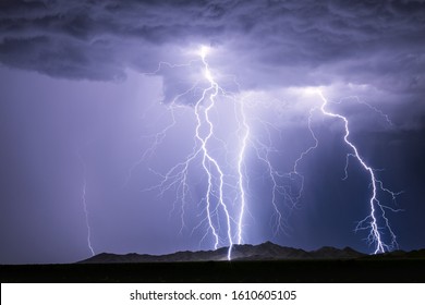 Lightning bolts strike from a thunderstorm at night