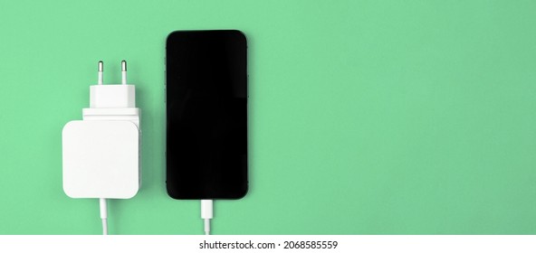 Lightning Charger Adapter For Mobile Phone. EU Type. Banner, Mint Background, Flat Lay, Top View And Copy Space 