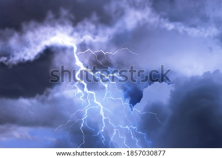 Lightning in dark cloudy sky during thunderstorm