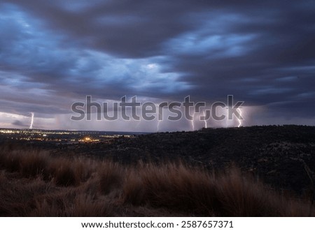 lightning in hills with stormy clouds