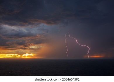Lightning in ocean during sunset