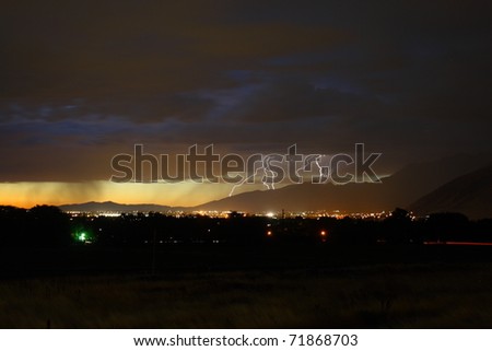 lightning storm in the evening with city lights