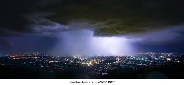 Lightning Storm Over City In Purple Light