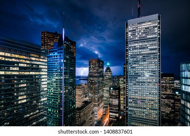 Lightning Storm Within The Toronto Financial District City Skyline Skyscrapers With Modern And Historic Building Construction And Development Views At Night
