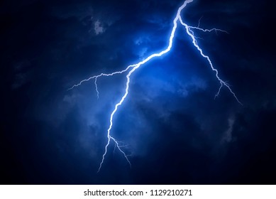 Lightning strike on a cloudy dramatic stormy sky. - Powered by Shutterstock - Get 15% off with code: PIKWIZARD15
