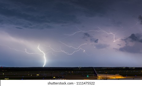 Lightning Strike Over An Airport At Night As A Cargo Plane Gets Loaded