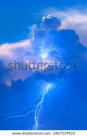 Lightning strikes between stormy clouds.