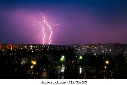 Lightning strikes down over the city at night. Beautiful shot. Long Exposure Photography