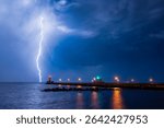 Lightning strikes Lake Superior behind the Duluth North Pier Lighthouse in Canal Park, Minnesota